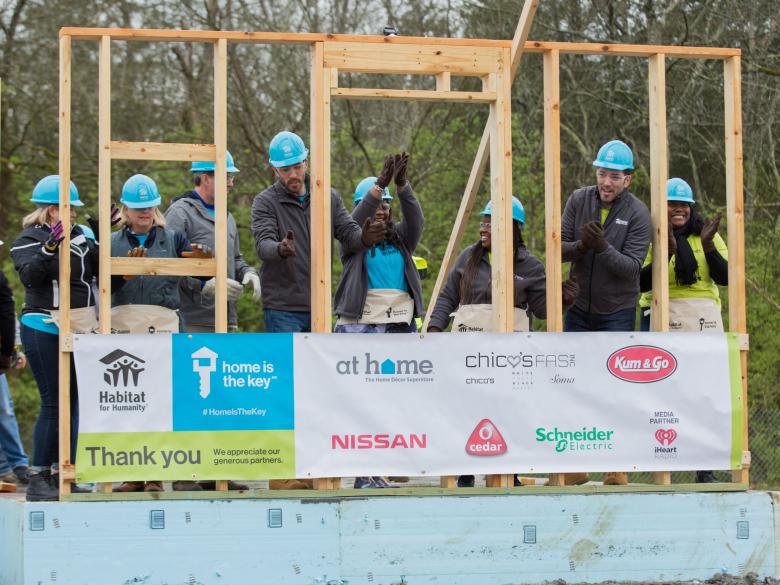 Scott Brothers, homeowners, and volunteers on build site