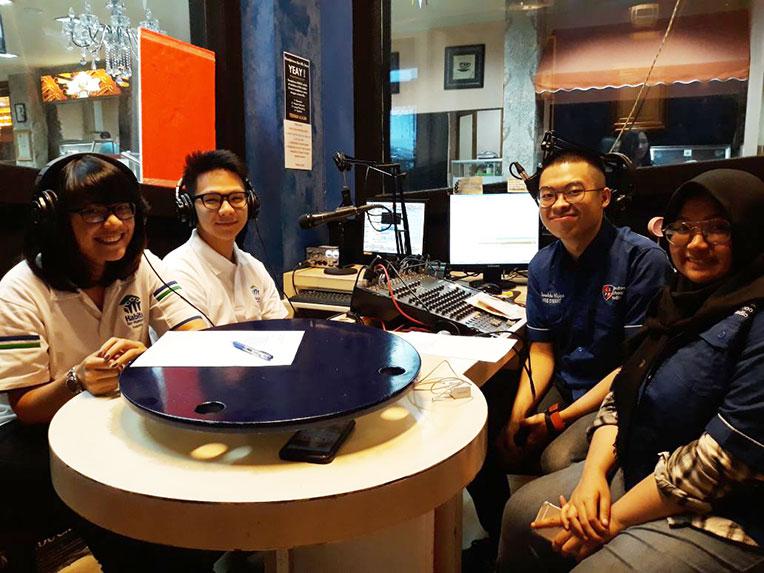 Habitat Indonesia youth volunteers at a radio show.