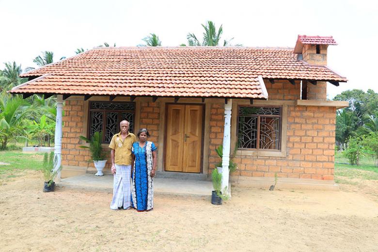 Nadarasa and his wife Yogeswary outside their new house.