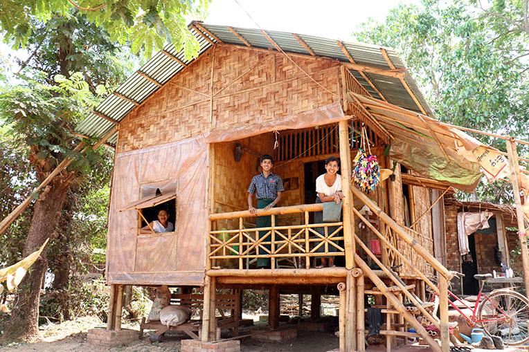Myint Myint Sein (right) with her mother-in-law Daw Yee (left) and son Hein Zaw Htet (center) in their Habitat home in Myanmar.