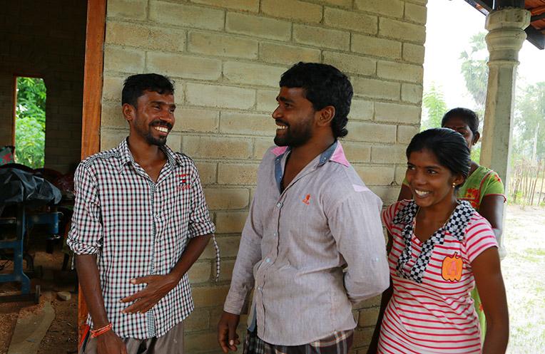 Head mason Sasikaran Thangavel (left) and the family with whom he build a CSEB house.