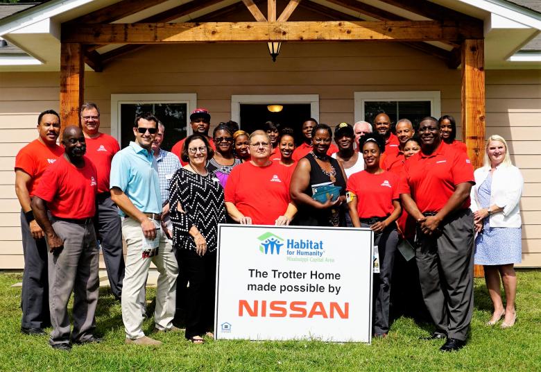 group of Nissan employees at house dedication.