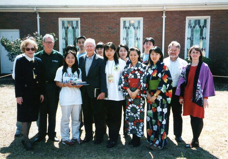 Mariko (second from left) between Habitat's most famous volunteers, former U.S. President Jimmy Carter and his wife Rosalynn,