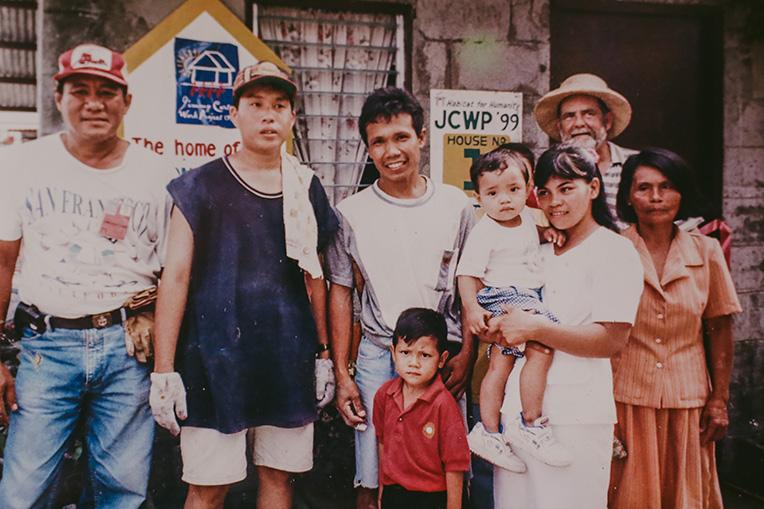 Annalyn, her husband and two sons with some of the 1999 Carter Work Project volunteers in Philippines