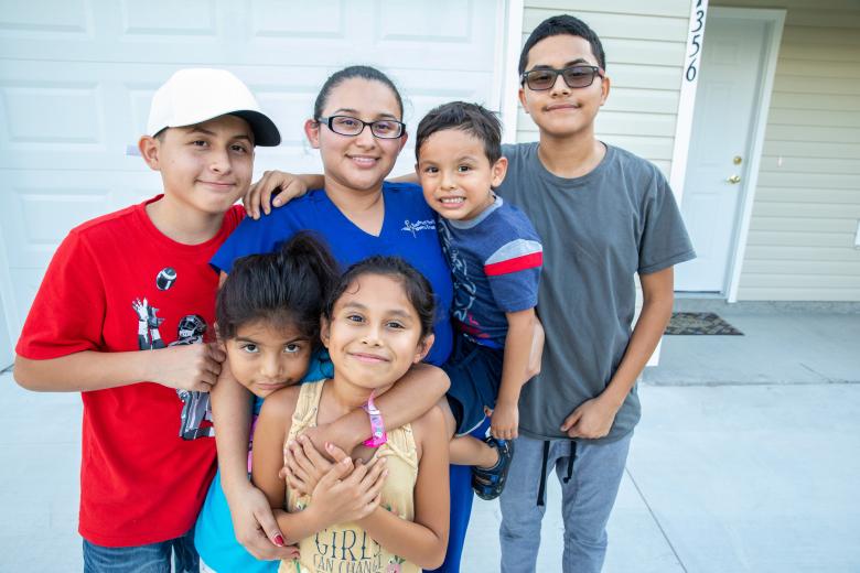 Ivonne and her family outside their Habitat home.