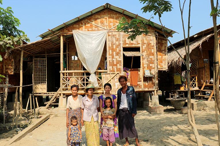 Daw Tin Aye (far left) and her family outside their Habitat home in Bago, Myanmar.