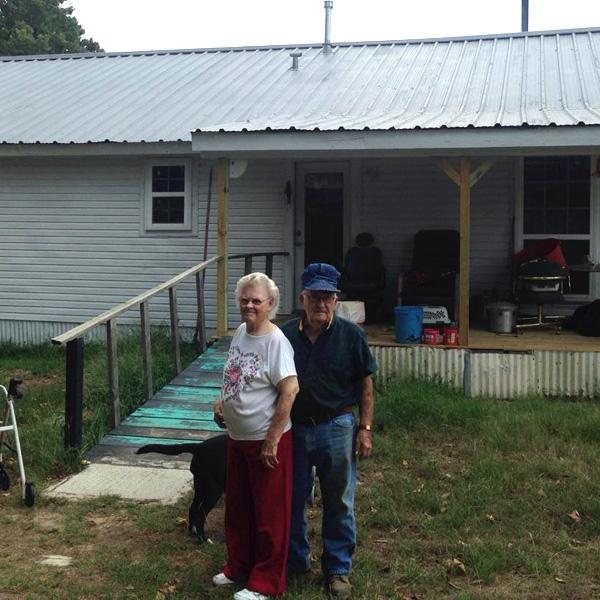 Arlett and Ruby standing in front of their home.