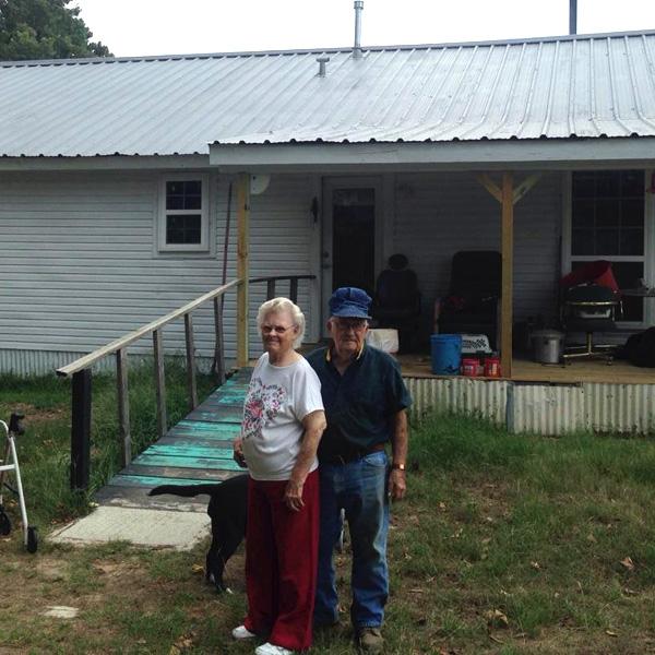 Arlett and Ruby standing in front of their home.