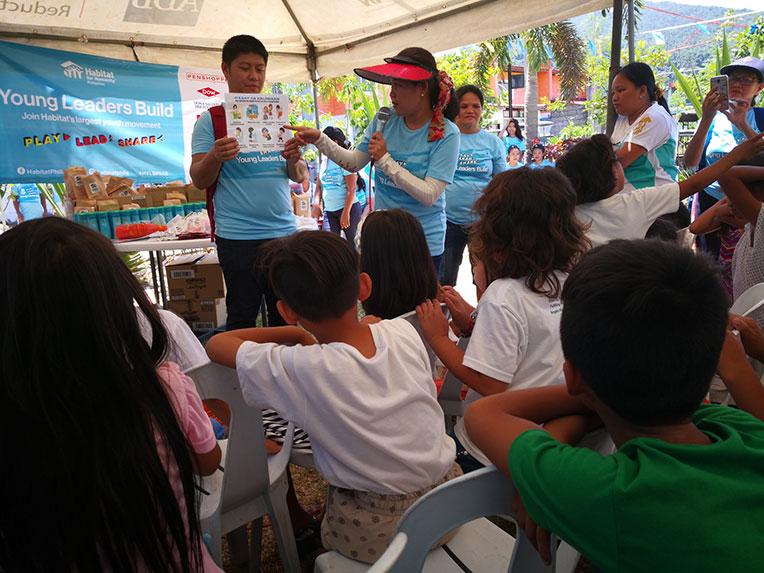 Habitat Philippines staff teaching better hygiene to children from the Calauan community in Philippines' Laguna province on culmination day of the 2018 Habitat Young Leaders Build.