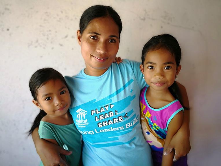 Habitat homeowner Maricel (center) with her daughters Kate (left) and Trisha (right).