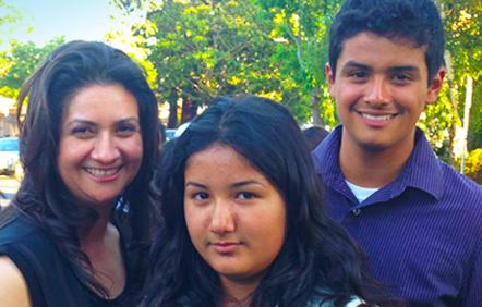 Dina Abarca and her two children stand together.