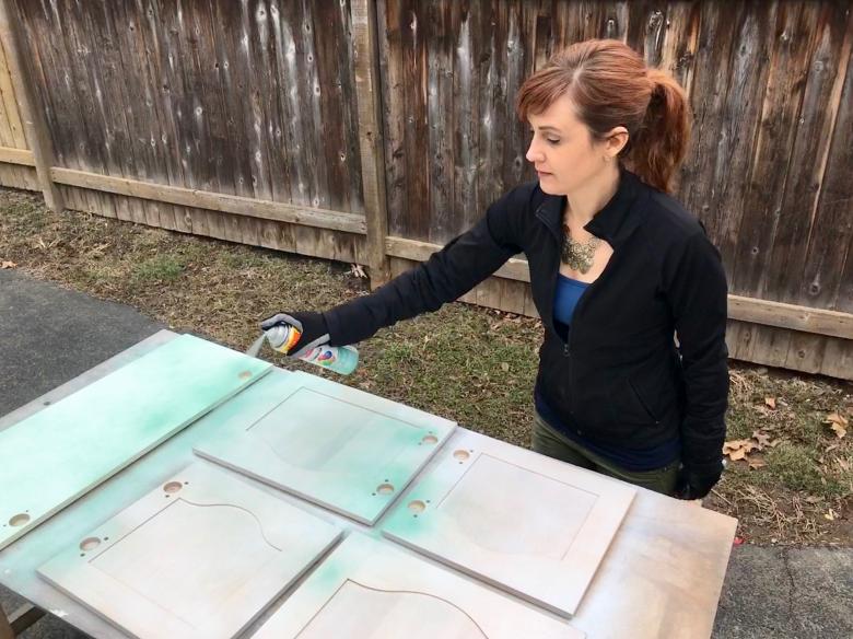 Theresa spray painting doors.