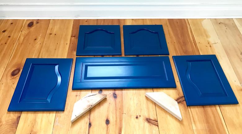 Five cabinet doors painted blue.