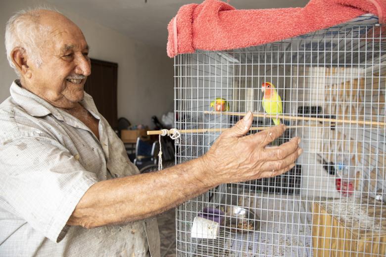 Antonio with pet parakeets.