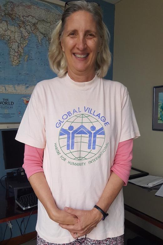 Karen Foreman wearing a T-shirt that says. "Global Village, Habitat for Humanity International."