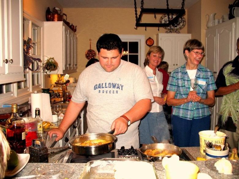 Luis in a kitchen preparing food.