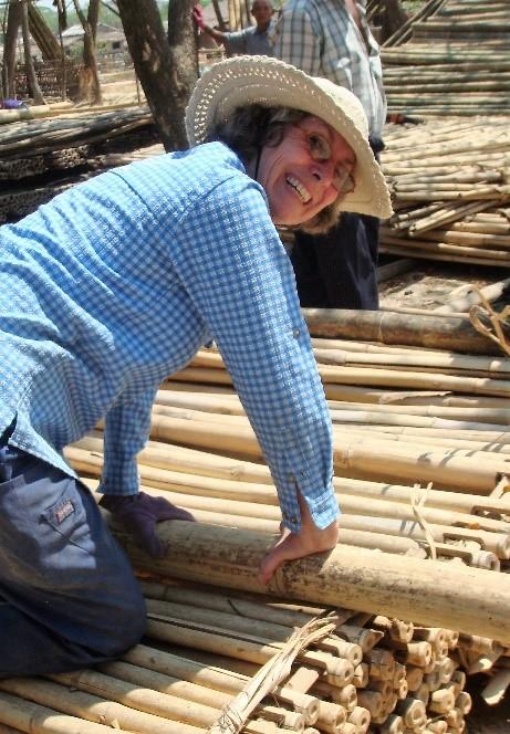 Val laying down wooden beams.