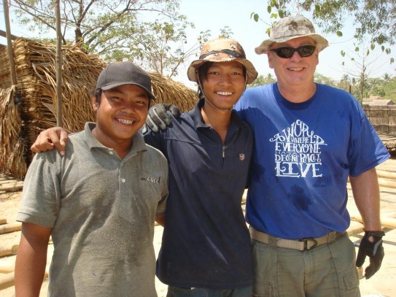 Nick with two community members in Myanmar.