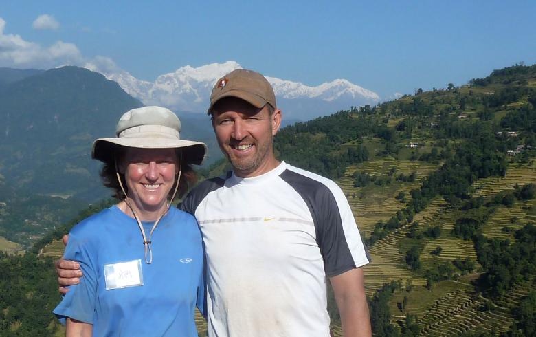 Val and Nick standing on a hilltop together.
