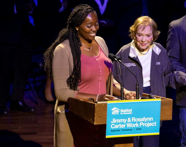 Future homeowner Tara stands with Rosalynn Carter at the opening ceremony for the Carter Work Project.