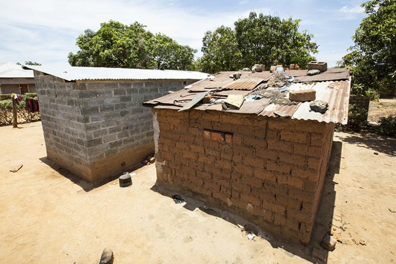 Lucy's new concrete block home next to her old mud-brick home.