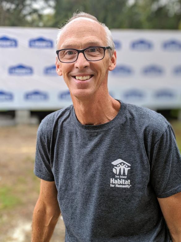 Dean on a build site, smiling.