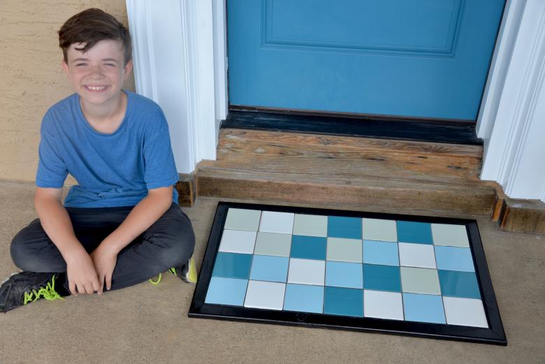 Jack sitting with the tile doormat.