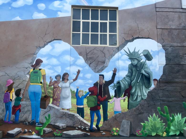 A colorful mural of people painted on a wall in Long Beach.