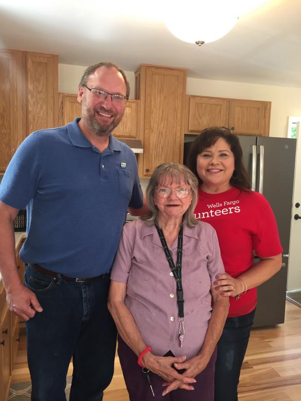 Marjorie  in her new home with volunteers.