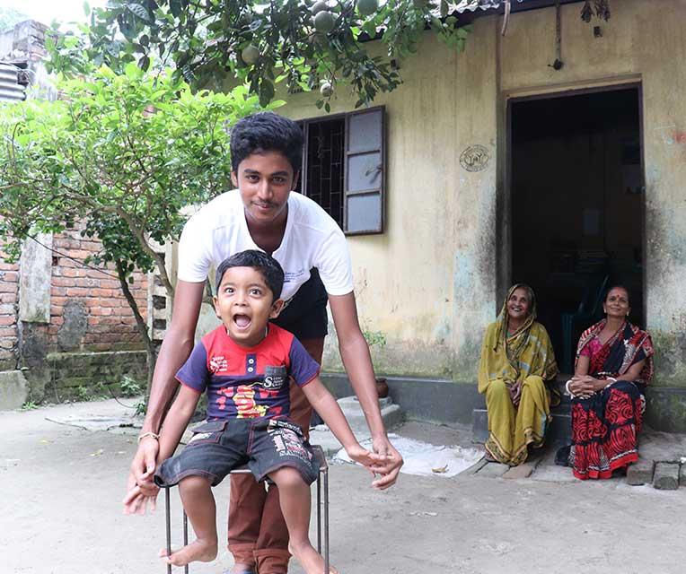 Dipu playing with his nephew with his grandmother and mother Joyantee watching on