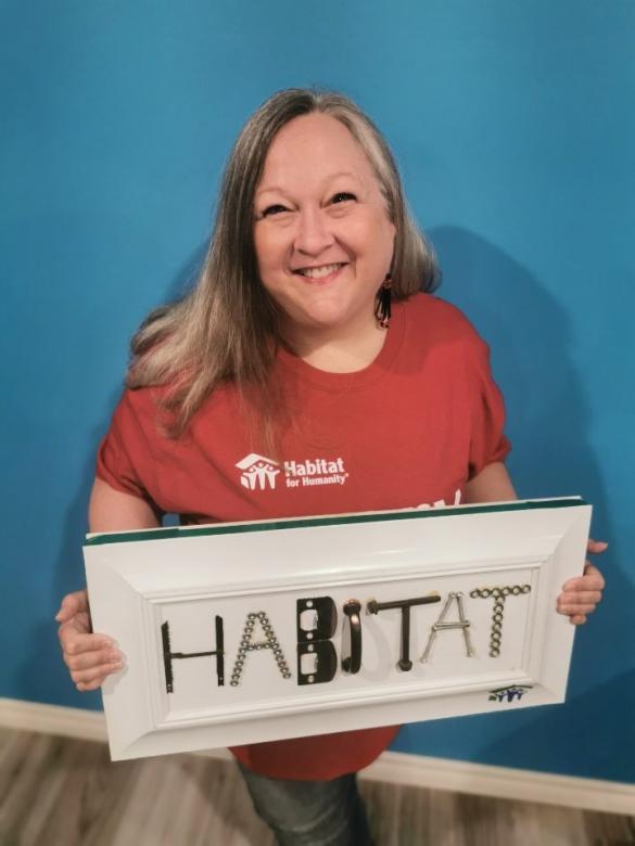 Lynda Henriksen with a sign that reads "Habitat."