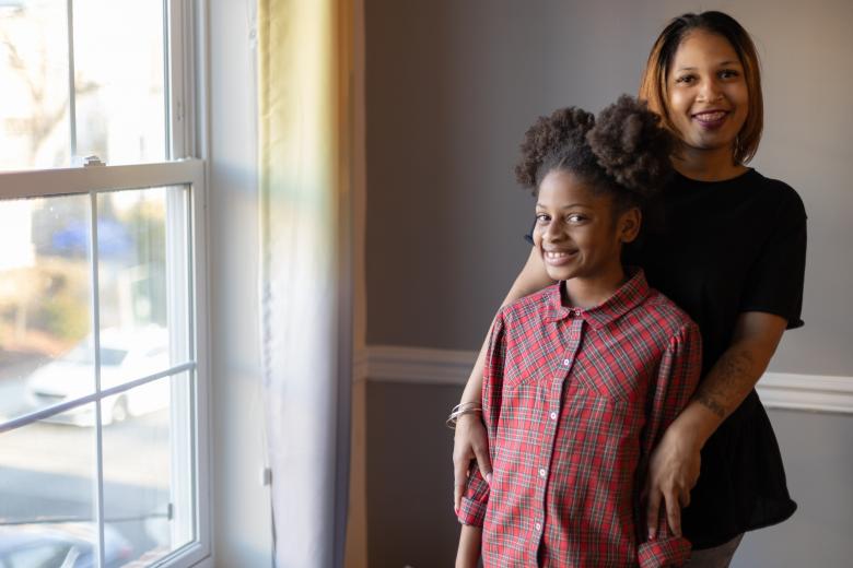 Shawnee and her daughter stand in their home together.