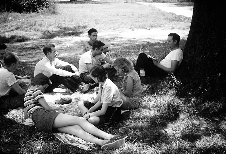 Clarence Jordan sitting outside with students.