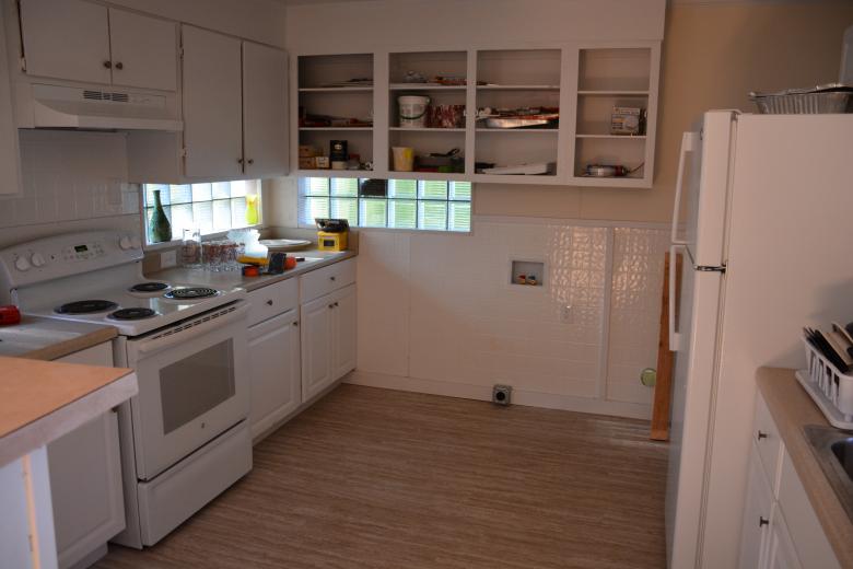 Fresh white kitchen with new flooring, cabinetry and appliances.