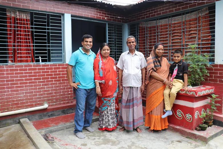 Ashish and his family outside their house in Mymensingh, Bangladesh