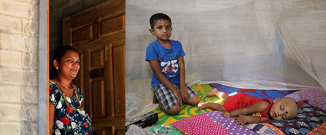 Anjalithevi (left) at her door and her elder son looking on as his younger brother slept.
