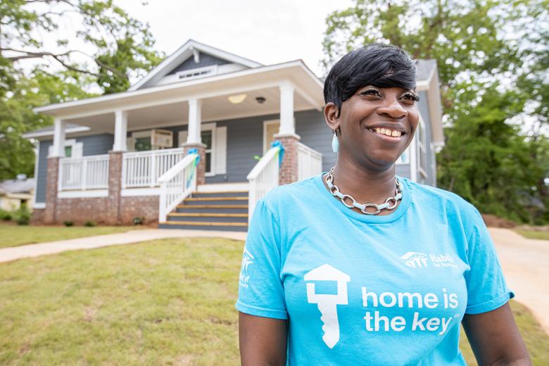 Krushetta standing in the yard in front of her craftsman style home.