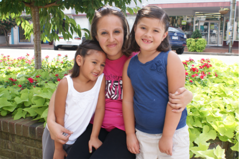 Yessica and her daughters posing together.