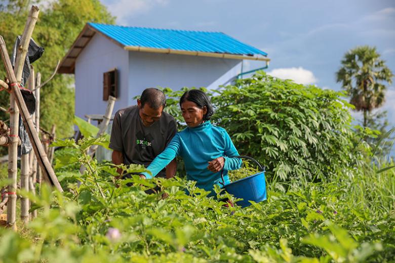 Cambodian homeowners Ny (right) and her husband Vann in their home garden