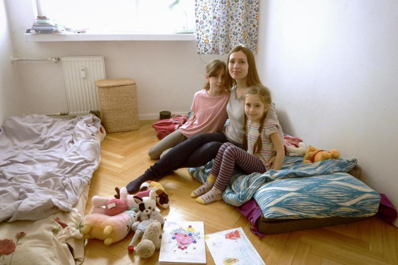 Marina and her two daughters in their temporary home.