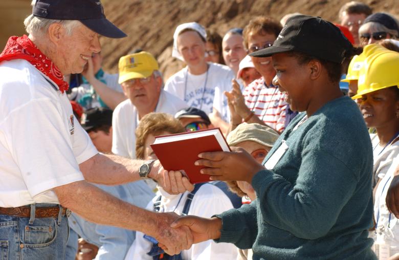 President Carter shaking hands with a homeowner.