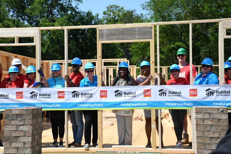 Wells Fargo volunteers help build Habitat for Humanity home for alongside Shaquawanda Boulware (center) in Charlotte, North Carolina