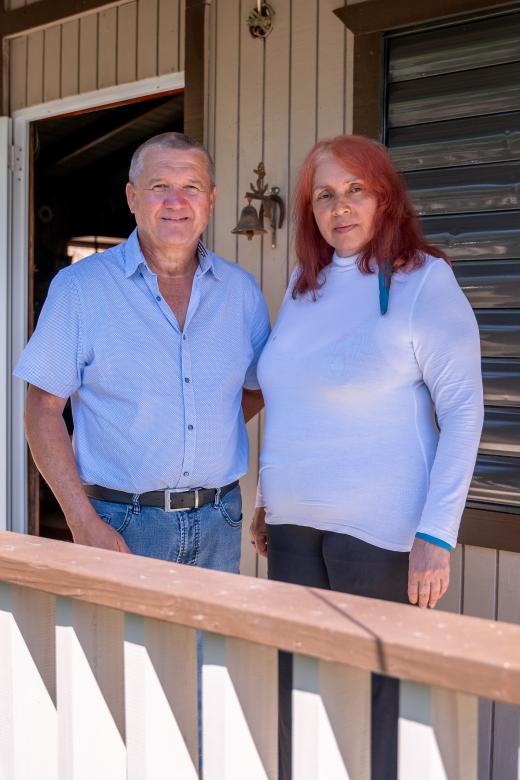 Antero and Luz in front of their Puerto Rico home repaired by Habitat