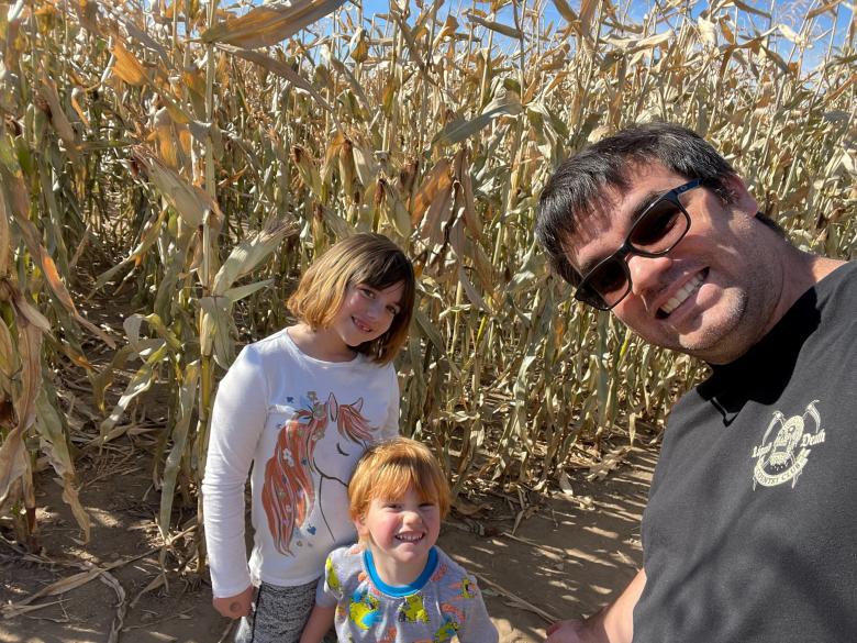 Selfie photo of David and kids smiling in a corn maze
