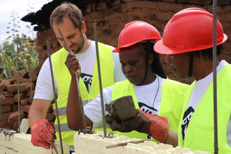 HRLOD team members fixing blocks using concrete and steel rods.