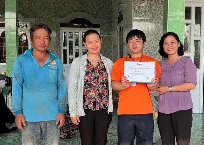 Ryusei Masuda (third from left) with his certificate of participation in a build in Vietnam