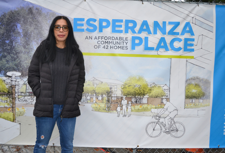 Woman in front of sign.