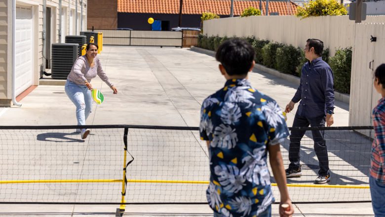 Family playing pickleball.