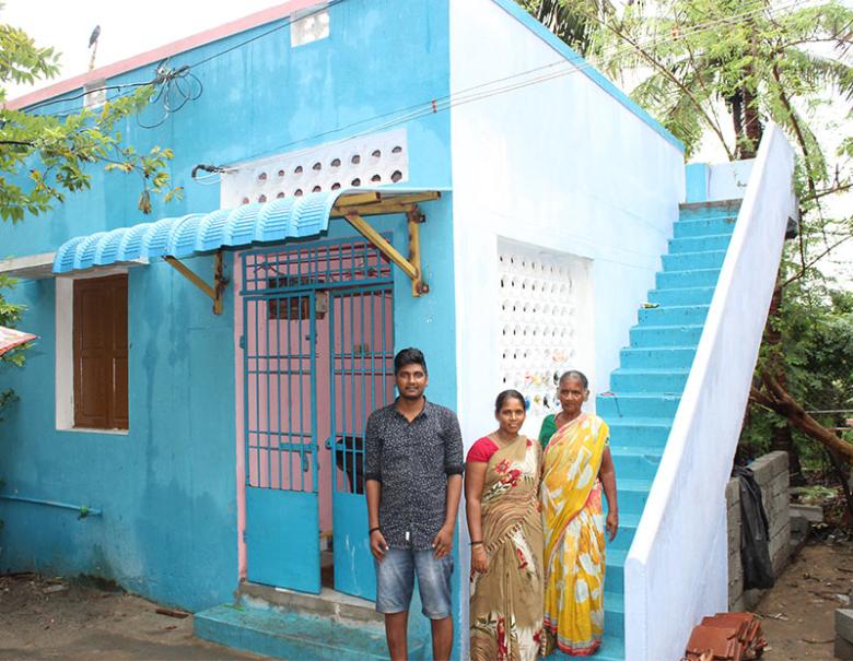 Porkalai (right), who survived 2004 tsunami, with her family members outside her home