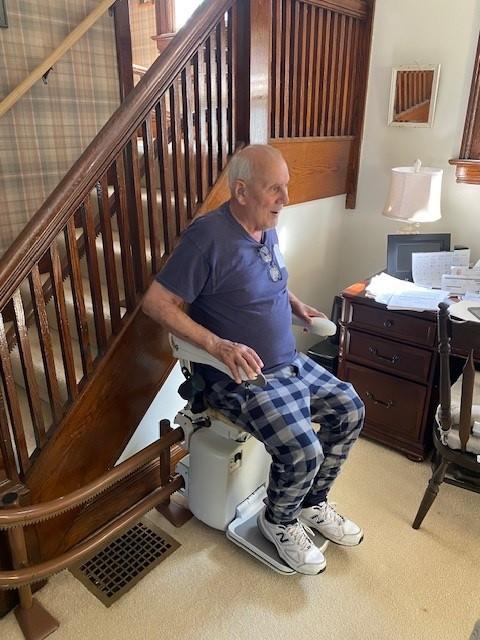 Richard sitting in the chair of his newly installed stair lift